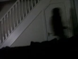 Shadow figure on staircase resembling a ghostly apparition – one of the classic signs your house is haunted.